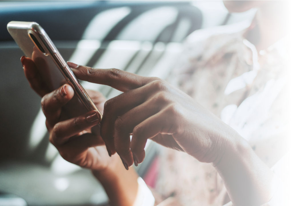 Hand of black female holding and using a cell phone