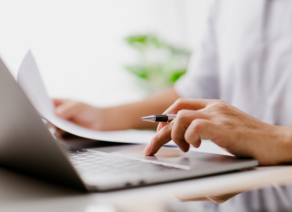 A person using a laptop to work while connected to high speed internet